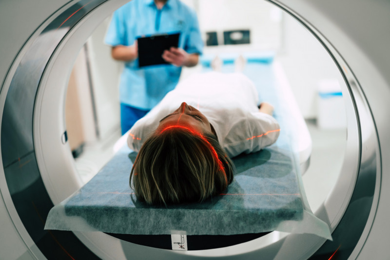 Young woman patient is ready to do magnetic resonance imaging in
